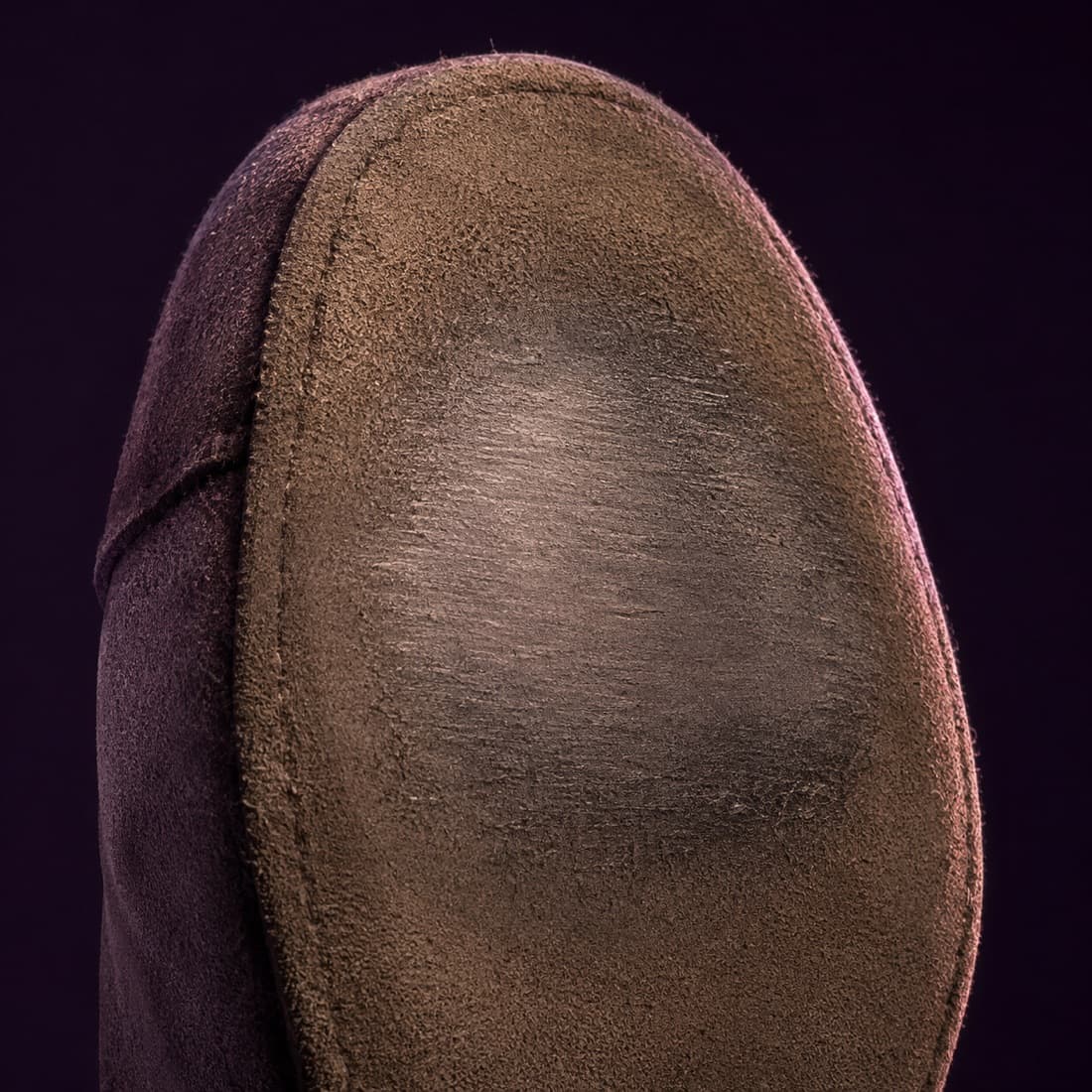 Macro of a worn suede sole polished smooth in the ball area